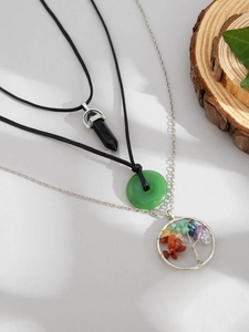 Detailed shot of multi-layer necklaces with crystal, jade pendants and tree of life charm