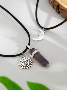 Detail of Bohemian layered necklaces with purple crystal prism, sun and moon pendants
