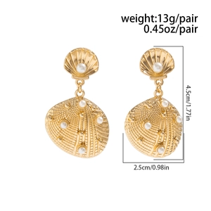 Detail view of golden shell earrings with white pearl accents and size dimensions