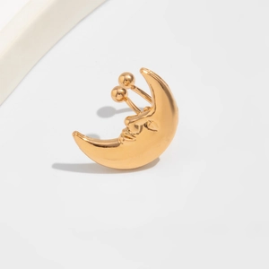Macro shot of gold celestial moon ear cuff with detailed face relief and ball screw back