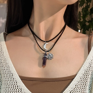 Bohemian layered necklace featuring silver sun and moon pendants with purple crystal stone