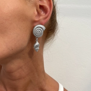 Silver conch shell dangle earrings with spiral texture shown on model for summer style