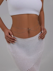 Close-up of double-layered silver waist chain with tiny metal beads on model