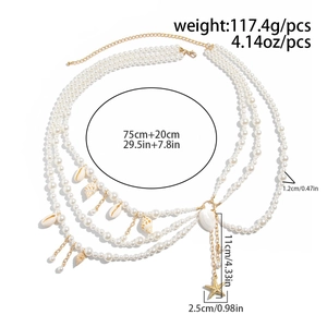 Detailed view of layered faux pearl body chain with shell and starfish charms measurements