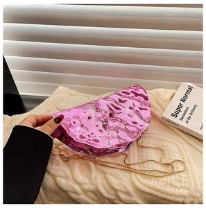 Detail view of metallic pink liquid wave texture evening bag with gold chain strap