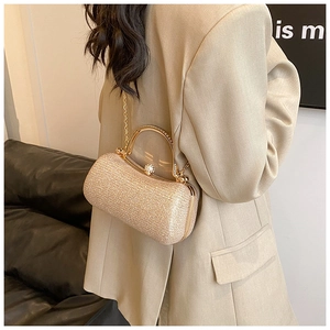 Detail of elegant champagne gold sequin evening clutch with metal handle and diamond clasp