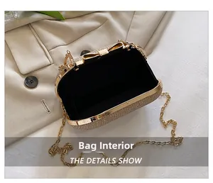 Interior view of gold glitter evening clutch with bow clasp and chain strap