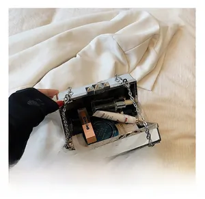 Interior view of silver mirror box clutch showing capacity for daily makeup and chain