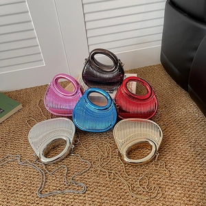Acrylic evening clutch bag with circular handle and metallic vertical striped texture