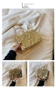 Detail of gold lava texture acrylic evening clutch with ring handle and chain strap