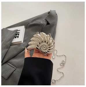 Makroaufnahme der silbernen Muschel-Abendtasche mit Nautilus-Spiral-Struktur
