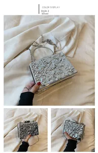 Close-up of silver acrylic box clutch with hammer-textured surface and metallic handle