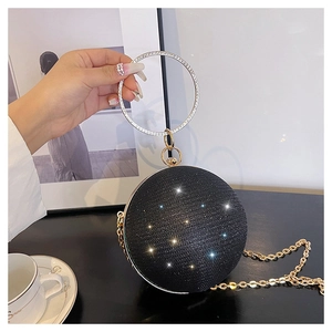 Détail du sac boule noir pailleté avec poignée anneau strass et fine chaîne dorée