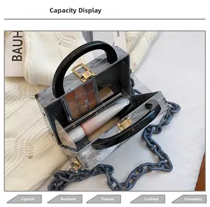 Macro shot of marble acrylic box bag capacity with cosmetics and chain strap
