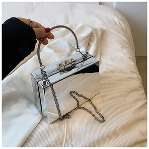 Detail of silver mirror acrylic box bag with metal handle and detachable chain strap