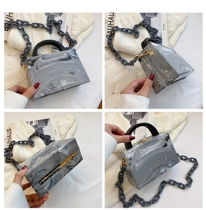 Detail of marble pattern acrylic square bag with thick chain and resin handle