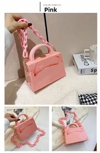 Detailed macro view of pink marble texture handbag with acrylic chain and gold clasp