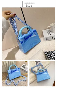 Close-up of blue marble acrylic box bag with chunky chain strap and top handle design