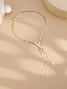 Detailed view of the 18K gold flat snake chain necklace with elegant braided knot design