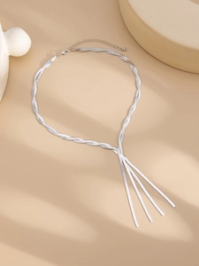 Detailed view of silver multilayer snake bone chain with flowing tassel pendants