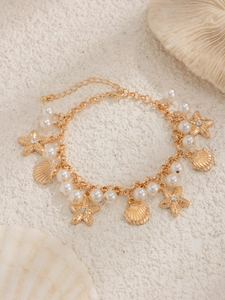 Detail of bohemian starfish shell anklet with faux pearls and gold adjustable chain
