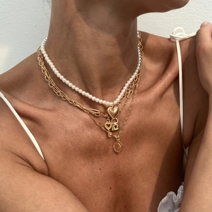 Layered gold necklace set with heart lock, key pendants and white beaded strand for women