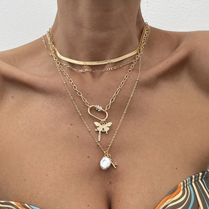 Chic multi-layer gold necklace featuring butterfly and baroque pearl charms for women
