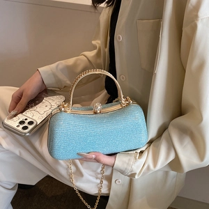 Sparkling light blue evening clutch with gold metal handle and rhinestone ball clasp