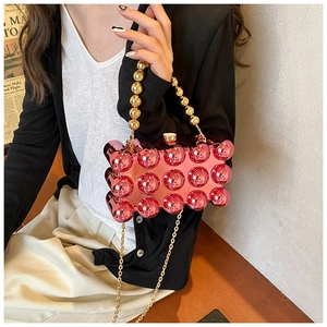 Pink metallic evening bag with 3D spherical studs and gold circular bead handle