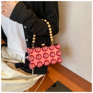 Pink beaded acrylic evening clutch with metallic studs and dual gold chain straps