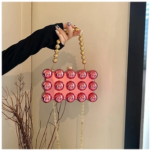 Pink acrylic ball evening bag with 3D studs and golden metallic bead handle details