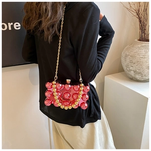 Detail of rose pink transparent beaded bubble bag with golden metal chain straps
