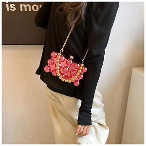 Pink acrylic perfume-bottle shaped bag with bubble texture and golden chain on model