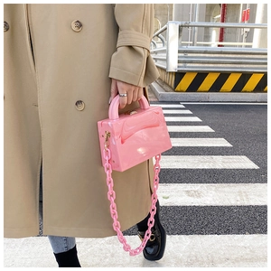 Detailed close-up of a pink marble acrylic crossbody bag with a chunky chain strap