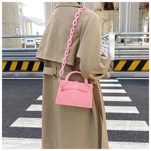 Detail of pink marble textured crossbody bag with thick acrylic chain strap