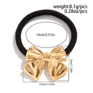 Detail view of golden bow hair tie with size specs and weight of 8.1g and 14cm diameter