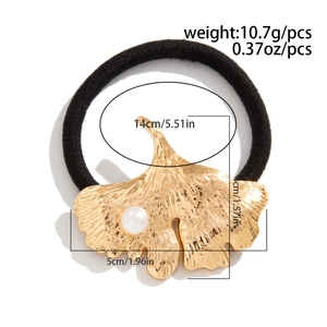 Detail view of gold ginkgo leaf hair tie with pearl, showing weight and dimensions