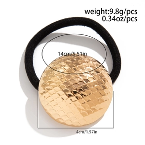 Detail showing weight and size measurements for the gold scale-texture heart hair tie