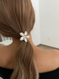 Silver flower ponytail holder hair tie accessory shown on brown hair ponytail