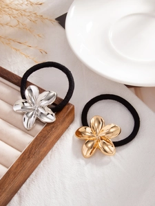 Close-up of gold and silver metallic flower hair ties with high-elastic black ropes