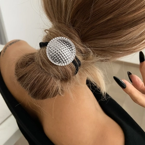 Close-up of hair tie featuring a silver textured geometric pendant on high elastic rope