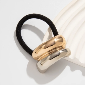 Detail of minimalist hair tie with dual-tone gold and silver metallic cylinder clasp