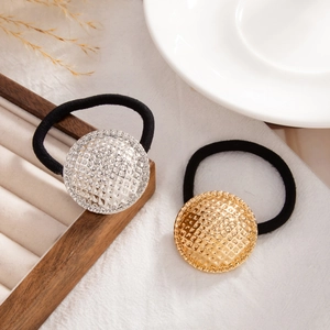 Detail of high-elasticity hair ties with gold and silver embossed metallic ornaments