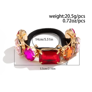 Detail of luxury hair tie with colorful multi-shape gemstones in gold claw settings