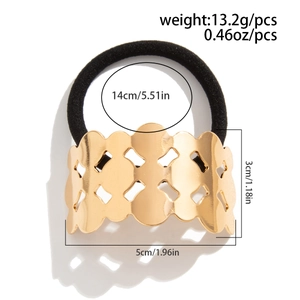 Detail view of golden hollow geometric metal hair tie with black elastic band