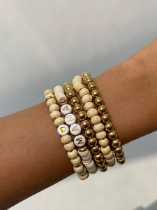 Detail of five-piece bohemian beaded bracelet set with MAMA letter beads on model