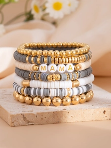 Detail of multi-layer Bohemian stretch bracelets featuring MAMA gold letter beads