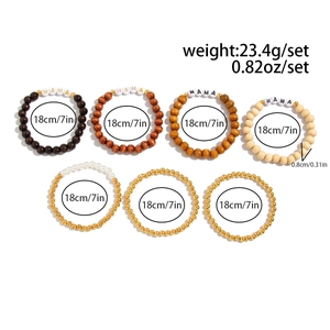 Macro detail of Bohemian 7-piece layered bracelet set with wood beads and MAMA charms