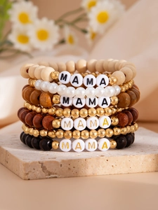 Detail of bohemian layered beaded bracelets with wood beads and MAMA letter charms