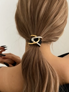 Chic ponytail holder with gold and silver geometric metal accents on black elastic band